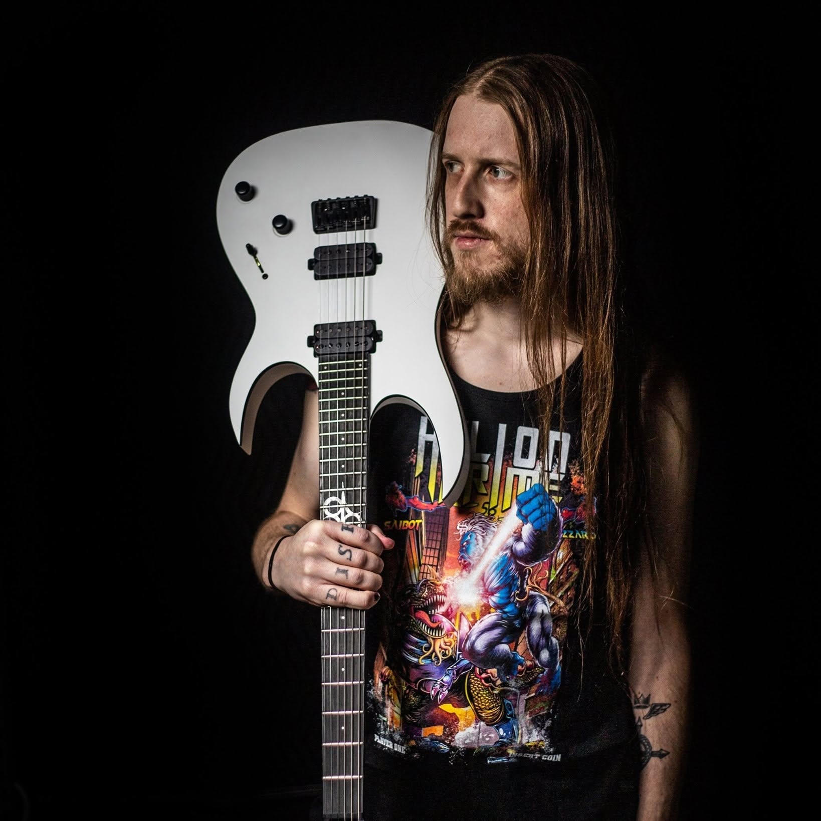 Chad Anderson holding a white electric guitar